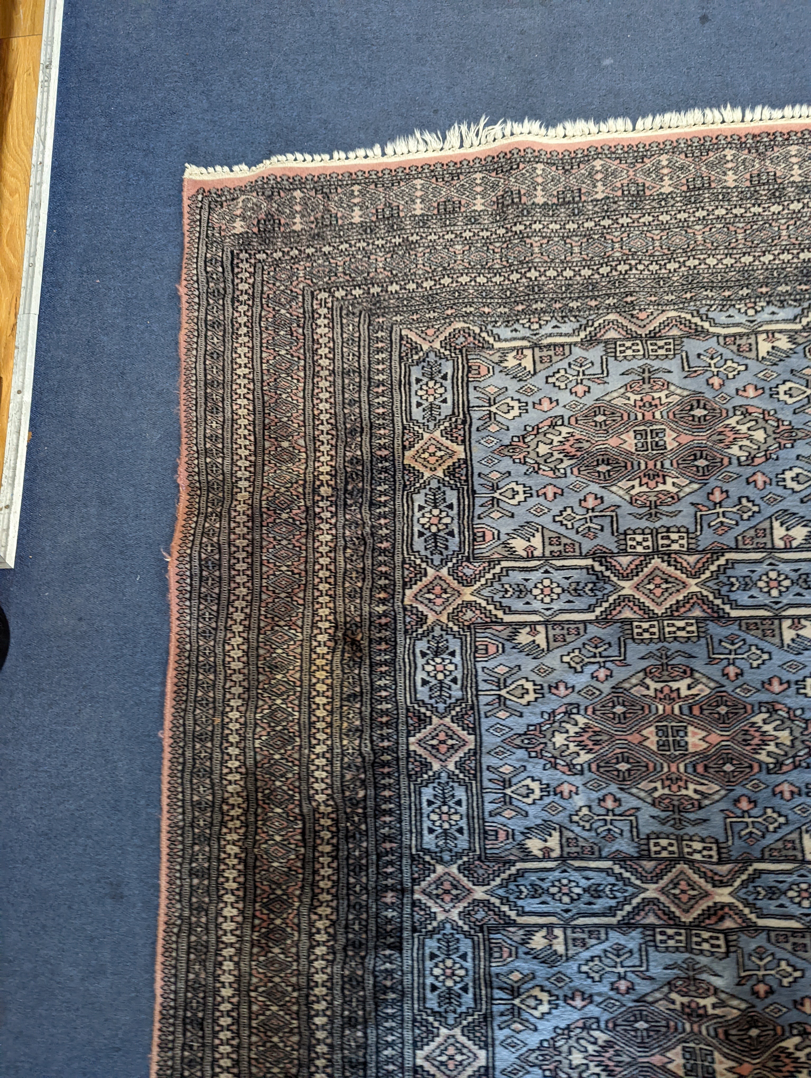 A Bokhara blue ground rug, 190 x 30cm
